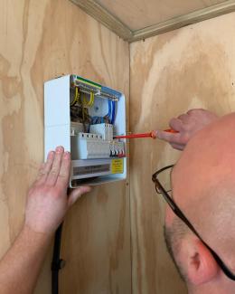 Electrician in Sawbridgeworth working on a fusebox