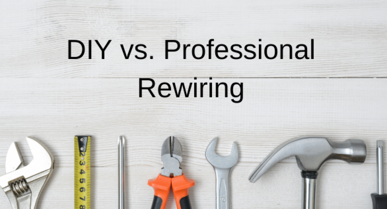 A row of tools on a pale grey background underneath the title DIY vs. Professional Rewiring: Making the Right Choice for Your home